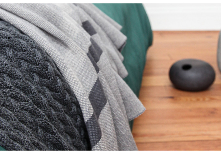 Throw with elephant print in blue, lilac, beige.