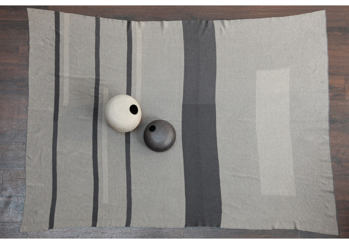 Throw with elephant print in blue, lilac, beige.