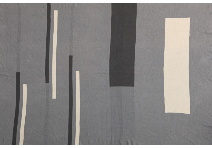 Throw with elephant print in blue, lilac, beige.