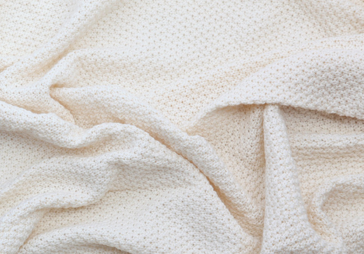 Throw made with fairtrade and organic cotton in blue, lilac, beige and grey