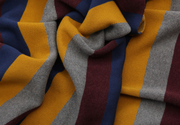 Throw made with fairtrade and organic cotton in blue, lilac, beige and grey